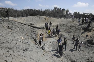 Palestinians search for bodies and survivors in a site hit by an Israeli bombardment on Khan Younis, southern Gaza Strip, Saturday, July 13, 2024.