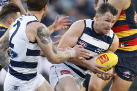 Patrick Dangerfield feels the heat as the Crows push Geelong at GMHBA Stadium.