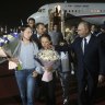 Russian President Vladimir Putin, foreground right, walks with released Russian prisoners and relatives upon their arrival at the Vnukovo government airport outside Moscow, Russia.