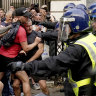 Protesters scuffle with police during the "Enough is Enough" protest in Whitehall, London, Wednesday July 31, 2024, following the fatal stabbing of three children at a Taylor Swift-themed summer holiday dance and yoga class on Monday in Southport. (Jordan Pettitt/PA via AP)