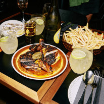 Oysters, fries and free-range chicken with burnt chilli nuoc mam at Firebird.