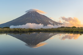 Reflection of Mount Taranaki at sunset. Egmont National Park, North Island, New Zealand. 