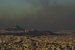 A general view of Athens with the Acropolis hill  is seen as fire burns the northern part of the city on Monday, Aug. 12, 2024, Hundreds of firefighters are tackling a major wildfire raging out of control on the fringes of the Greek capital.