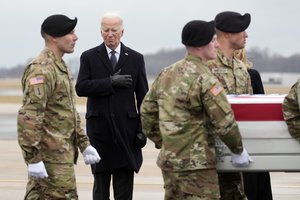 File - President Joe Biden watches as an Army carry team moves the flag-draped transfer case containing the remains of U.S. Army Sgt. Kennedy Ladon Sanders, 24, of Waycross, Ga. during a casualty return at Dover Air Force Base, Del., Friday, Feb. 2, 2024. Sanders was killed in a drone attack in Jordan on Jan. 28.