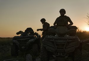 Ukrainian soldiers ride all-terrain vehicles at the front line near Bakhmut, one of the longest battles with Russian troops, Ukraine, Monday, Aug. 14, 2023