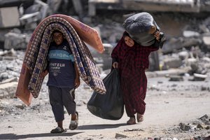 Palestinians displaced by the Israeli air and ground offensive on the Gaza Strip flee from Hamad City, following an evacuation order by the Israeli army to leave parts of the southern area of Khan Younis, Sunday, Aug. 11, 2024.