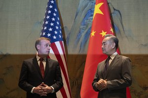 Wang Yi, right, the director of the Communist Party's Central Foreign Affairs Commission Office and White House national security adviser Jake Sullivan, left, look at each other before their talk at Yanqi lake in Beijing, Tuesday, Aug. 27, 2024.