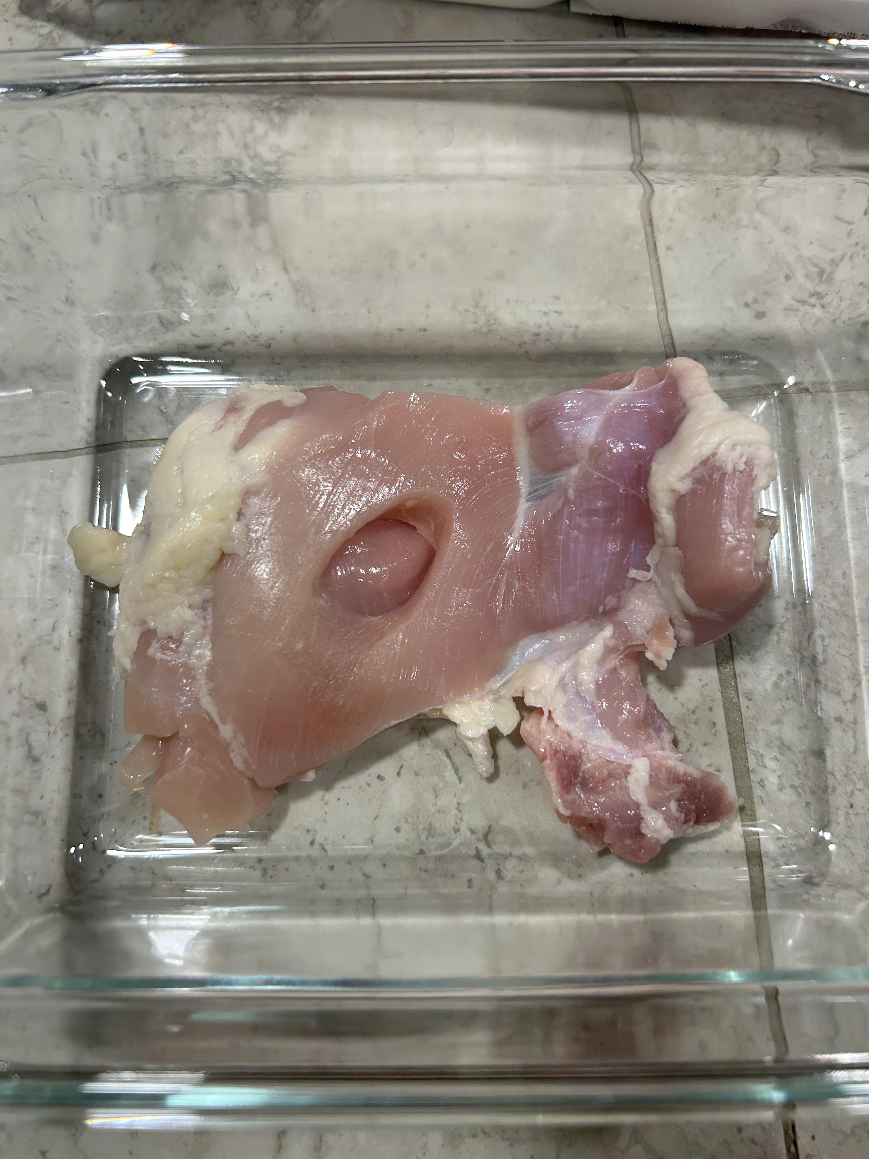 r/mildlyinteresting - My chicken thigh had a mysterious hole in the middle of it.