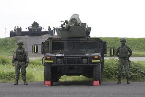 Soldiers stand beside a M1167 HMMWV (High Mobility Multipurpose Wheeled Vehicle) anti-tank missile carriers during military drills in Pingtung County, southern Taiwan, Monday, Aug. 26, 2024. Taiwan drilled Monday with anti-amphibious landing missiles as part of strategy to remain mobile and deadly in an attempt to deter an attack from China, which claims the democratically ruled island as its own territory to be brought under its control by force if necessary. (AP Photo/Chiang Ying-ying)