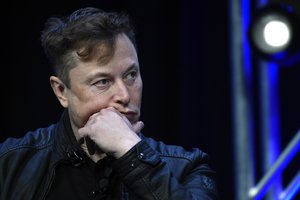 FILE - Tesla and SpaceX chief executive officer Elon Musk listens to a question as he speaks at the SATELLITE Conference and Exhibition in Washington, March 9, 2020.