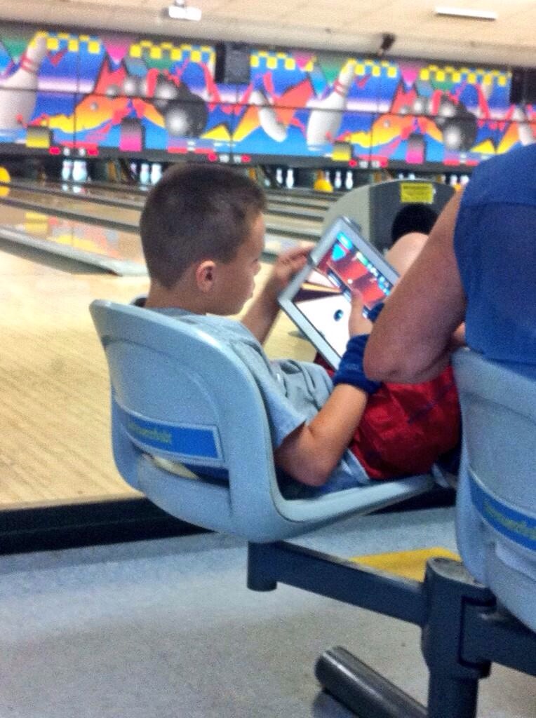 r/mildlyinfuriating - This kid is playing a bowling game at a bowling alley.