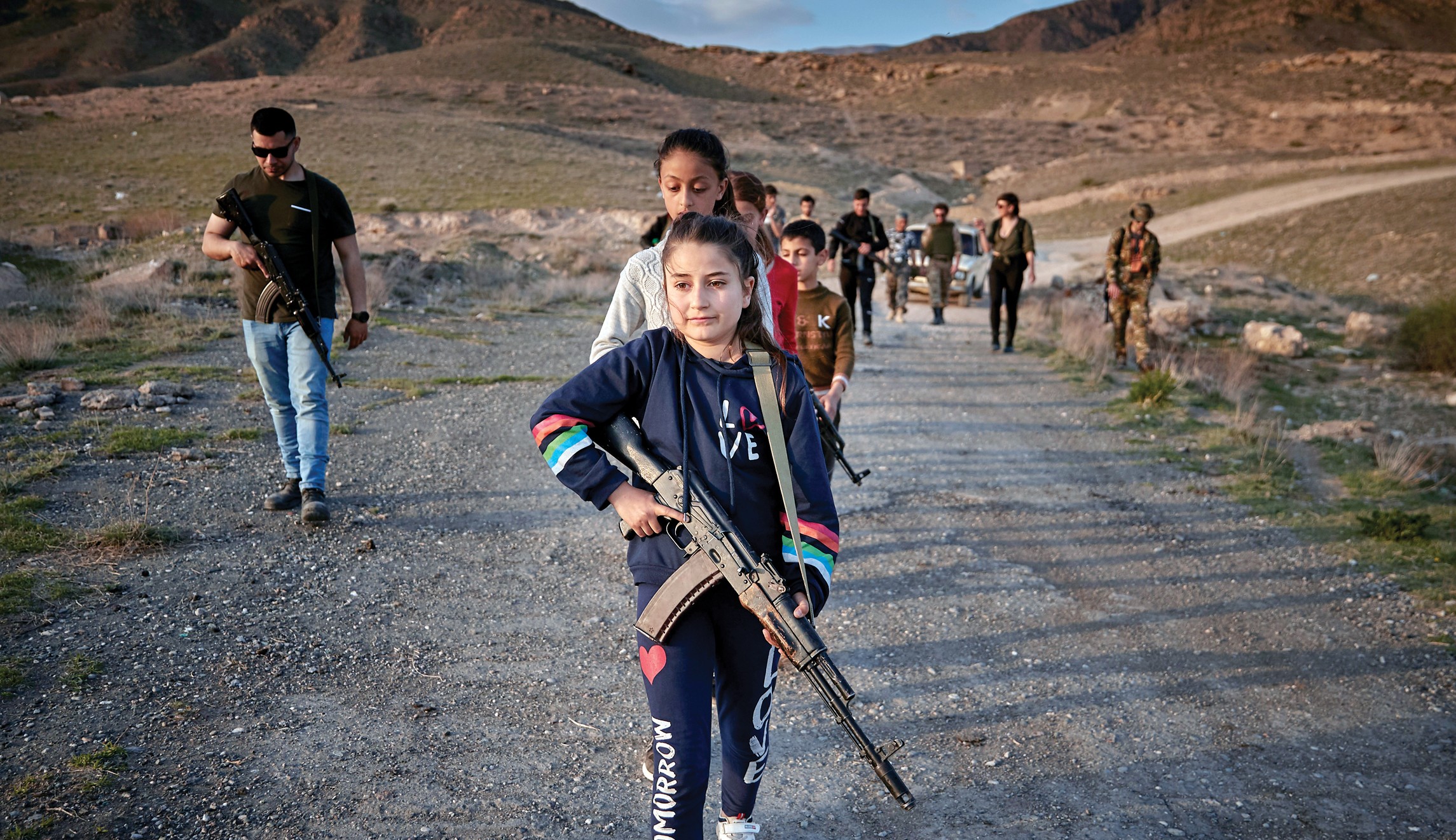 r/pics - Little Armenian girl training with a machine gun to protect her village bordering Azerbaijan/Turkey