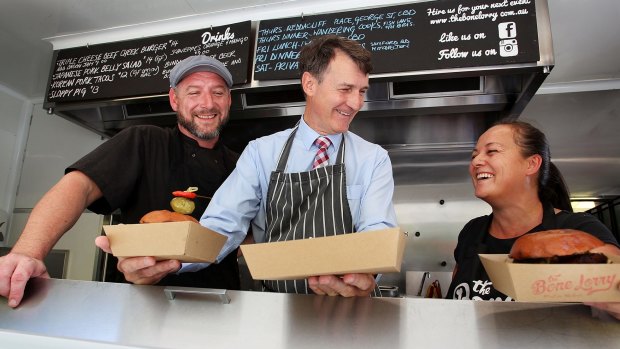 Lord Mayor Graham Quirk on board the Bone Lorry food truck with owners Joel Chrystal and Eileen Taylor-Chrystal. Food trucks have proven to be 'exceptionally' safe, Cr Quirk says.