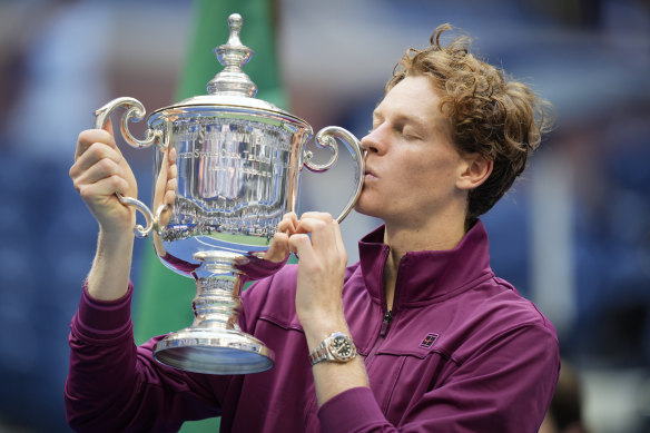 Jannik Sinner kisses the US Open trophy after defeating Taylor Fritz.