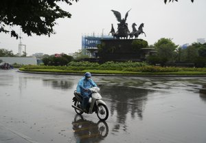 A man rides motorcycle in the rain caused by typhoon Yagi in Hanoi, Vietnam Saturday, Sept. 7, 2024.