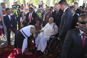 Pope Francis is greeted by East Timorese who wearing traditional dresses during a welcoming ceremony at Dili Presidente Nicolau Lobato International Airport in Dili, East Timor, Monday, Sept. 9, 2024.