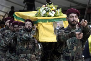 File - Hezbollah fighters carry the coffin of their comrade, senior commander Yasser Nemr Qranbish, who was killed by an Israeli airstrike that hit his car in Syria near the border with Lebanon, during his funeral procession in the southern suburbs of Beirut, Lebanon, Wednesday, July 10, 2024. The Israeli strike in Syria Tuesday killed Qranbish, a former personal bodyguard of Hezbollah leader, an official with the Lebanese militant group said.