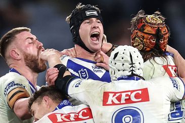 Bulldogs teammates swamp Matt Burton after a match-winning field-goal against the Sharks in round 17.