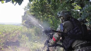 In this photo taken from video released by the Russian Defense Ministry on Monday, Aug. 19, 2024, Russian soldiers fire an AGS-17 automatic grenade launcher towards Ukrainian positions at an undisclosed location in the Russian - Ukrainian border area in ​​the Kursk region, Russia.