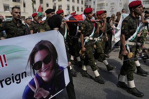 A Palestinian honor guard carries the body of Aysenur Ezgi Eygi, 26, who a witness says was fatally shot by Israeli soldiers while participating in an anti-settlement protest in the West Bank, during her funeral procession in the West Bank city of Nablus, Monday, Sept. 9, 2024.