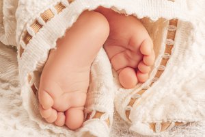 Small feet of a sleeping baby boy, close-up