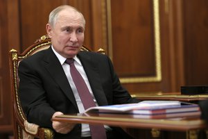 Russian President Vladimir Putin listens to Chairman of the Russian Federation of Independent Trade Unions Mikhail Shmakov during their meeting at the Kremlin in Moscow, Russia, Monday, Jan. 22, 2024