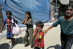 Palestinian children are evacuated from a site hit by an Israeli bombardment on Khan Younis, southern Gaza Strip, Saturday, July 13, 2024. Israel said it targeted Hamas' shadowy military commander in a massive strike Saturday in the crowded southern Gaza Strip that killed at least 71 people, according to local health officials. Hamas immediately rejected the claim that Mohammed Deif was targeted.