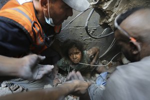 Palestinians try to pull a girl out of the rubble of a building that was destroyed by Israeli airstrikes in Jabaliya refugee camp, northern Gaza Strip, Wednesday, Nov. 1, 2023