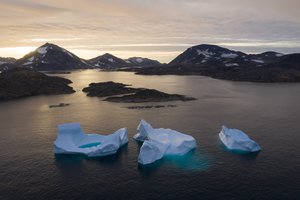 File - Large Icebergs float away as the sun rises near Kulusuk, Greenland, Aug. 16, 2019.