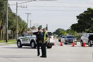 Police officers direct traffic near Trump International Golf Club after the apparent assassination attempt of Republican presidential nominee former President Donald Trump in West Palm Beach, Fla., Sunday, Sept. 15, 2024.