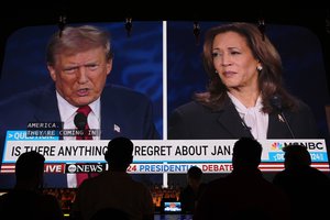 People watch the presidential debate between Republican presidential nominee former President Donald Trump and Democratic presidential nominee Vice President Kamala Harris, Tuesday, Sept. 10, 2024, at the Gipsy Las Vegas in Las Vegas.