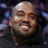 Kanye West, known as Ye, watches an NBA basketball game in Los Angeles.