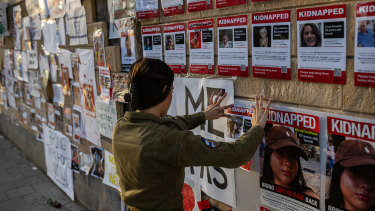  An Israeli soldier posts a photograph of a hostage in Tel Aviv, Israel.