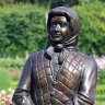 The sculpture of Queen Elizabeth II - clad in a headscarf, tartan skirt and quilted vest - standing next to the previously erected statue of her husband, Prince Philip in Parterre Garden.