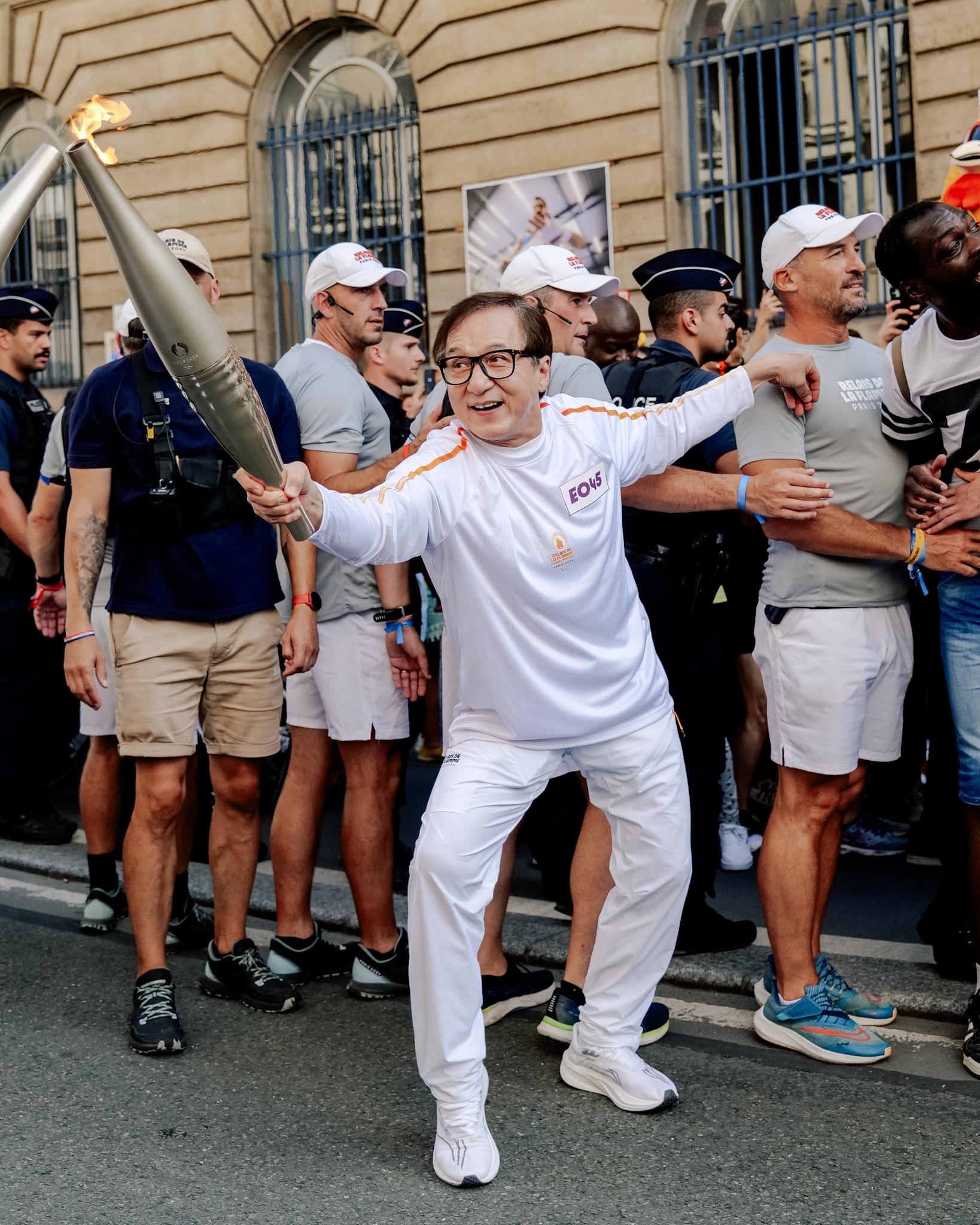 r/pics - Jackie Chan carries torch during Paralympic relay in Paris