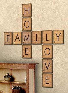 scrabble tiles spelling the word family love on a wall next to a bookcase