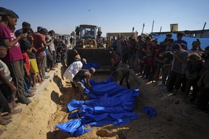 People bury the bodies of Palestinians taken by the Israeli military during operations in Gaza and returned this week, in Khan Younis, Gaza Strip, Thursday, Sept. 26, 2024.