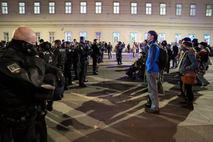 Austrian riot police officers block off and face anti right wing protesters, in Vienna, Austria, Sunday, Sept. 29, 2024, after polls closed in the country's national election.