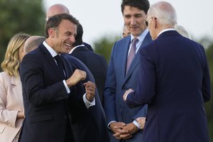 File - French President Emmanuel Macron, left, talks to U.S. President Joe Biden next to Canada's Prime Minister Justin Trudeau, center, as they gather to watch a skydiving demo during the G7 world leaders summit at Borgo Egnazia, Italy, Thursday, June 13, 2024.