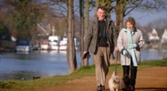 Couple walking alongside the River Thames