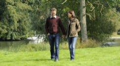 Couple walking by the River Thames in Marlow