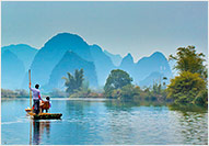 Men sailing down a river on a raft