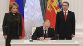 Russian President Vladimir Putin (C) signs documents as Sergei Naryshkin (R), speaker of the State Duma, Russia's lower parliament house, and Valentina Matviyenko, head of the Federation Council, look on during a ceremony in Moscow's Kremlin March 21, 2014. Putin signed legislation on Friday that completed the process of absorbing Crimea into Russia, defying Western leaders who say the Black Sea peninsula remains part of Ukraine. REUTERS/Mikhail Klimentyev/RIA Novosti/Kremlin (RUSSIA - Tags: POLITICS TPX IMAGES OF THE DAY) ATTENTION EDITORS - THIS IMAGE HAS BEEN SUPPLIED BY A THIRD PARTY. IT IS DISTRIBUTED, EXACTLY AS RECEIVED BY REUTERS, AS A SERVICE TO CLIENTS