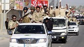 Shi'ite volunteers, who have joined the Iraqi army to fight against the predominantly Sunni militants from the radical Islamic State of Iraq and the Levant (ISIL), parade down a street in Kerbala, southwest of Baghdad, June 26, 2014. Iraqi forces launched an airborne assault on rebel-held Tikrit on Thursday with commandos flown into a stadium in helicopters, at least one of which crashed after taking fire from insurgents who have seized northern cities. REUTERS/Mushtaq Muhammed (IRAQ - Tags: CIVIL UNREST POLITICS MILITARY)