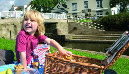 Child having a canalside picnic