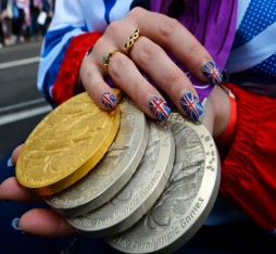 A Paralympic athlete shows off her tally of one Gold and three silver London 2012 Paralympic medals during the celebratory Team GB Athletes Parade after a successful London 2012 Olympic and Paralympic Parade.