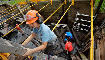 A volunteer on a ladder, exiting an empty lock