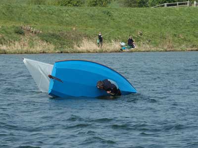 capsized sailing dinghy