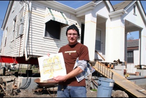 Eric Martin stands in front of his home in Gentilly holding a sketch of what his house will look like after elevation and repairs are completed. He will elevate his house to 11' which is above the current base flood elevation.