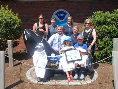 One millionth Aquarium visitor poses with family, friends, and staff